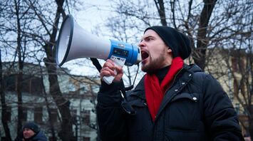 Man speaking through megaphone during protest