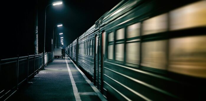 Night train arriving at station platform in the dark