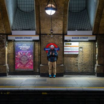 Passenger standing on Baker Street Underground platform in London