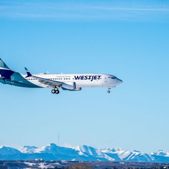 WestJet aircraft flying in clear sky