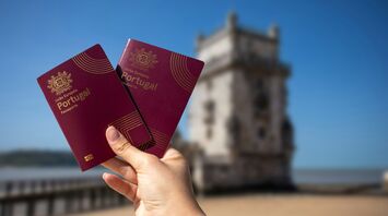 Portuguese passports held near Belém Tower in Lisbon