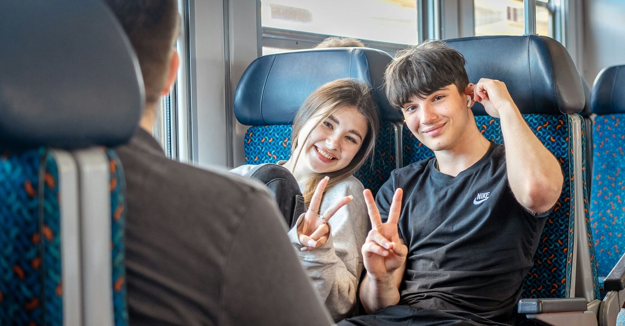 Young travellers sitting on train during journey