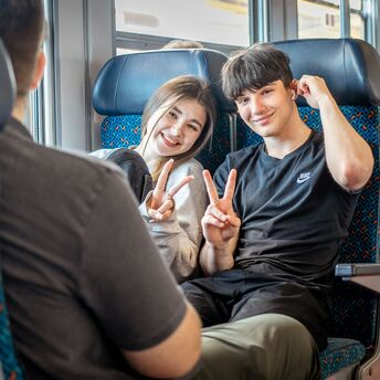 Young travellers sitting on train during journey