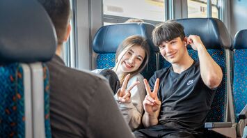 Young travellers sitting on train during journey