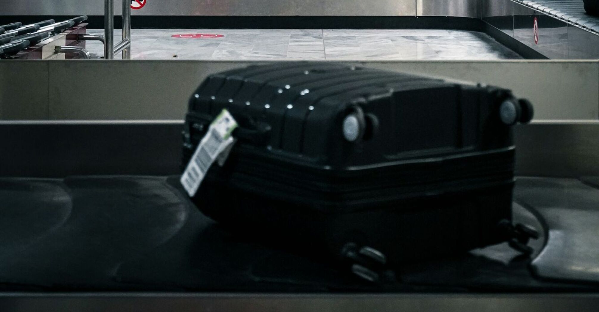Suitcase on airport baggage carousel belt