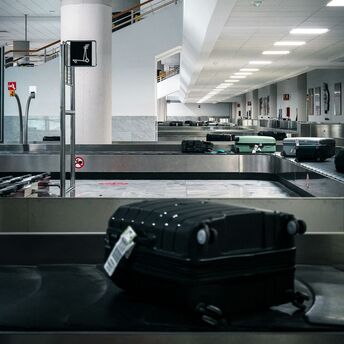Suitcase on airport baggage carousel belt