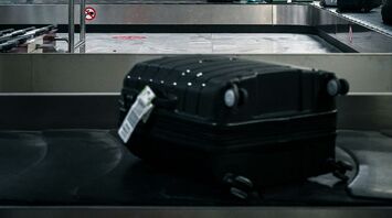Suitcase on airport baggage carousel belt
