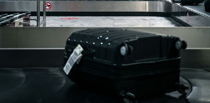 Suitcase on airport baggage carousel belt