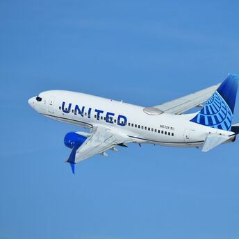 United Airlines plane flying in clear sky