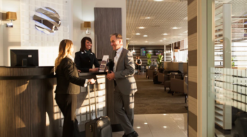 Passengers checking in at an airport lounge