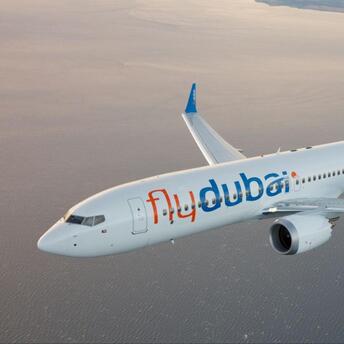 flydubai aircraft flying over coastal waters