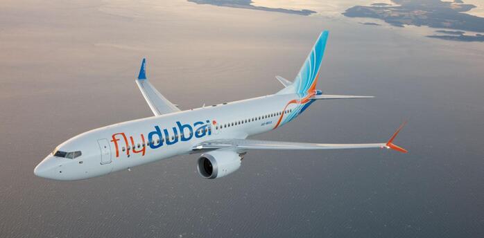 flydubai aircraft flying over coastal waters