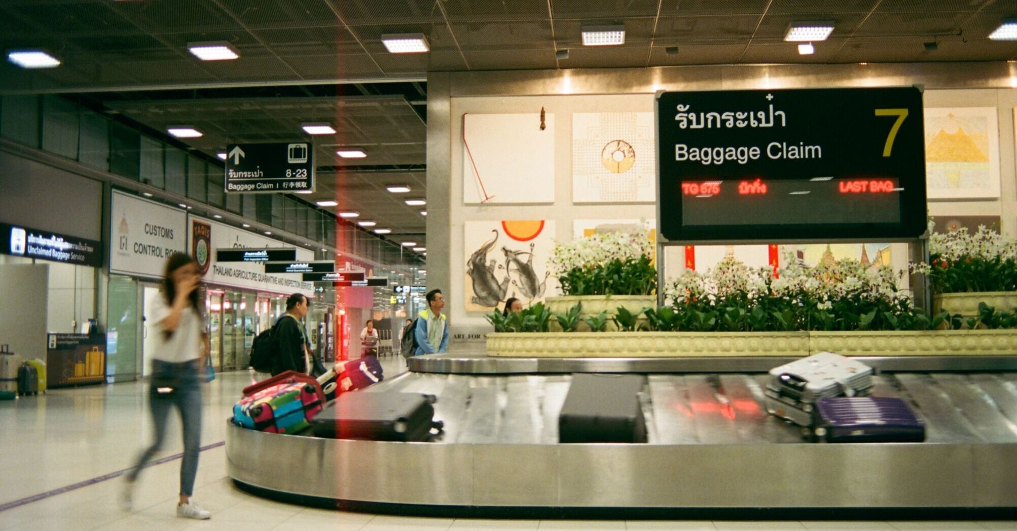 Baggage claim carousel with suitcases at an airport