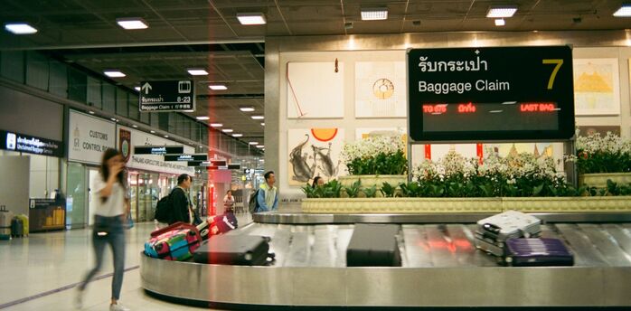 Baggage claim carousel with suitcases at an airport