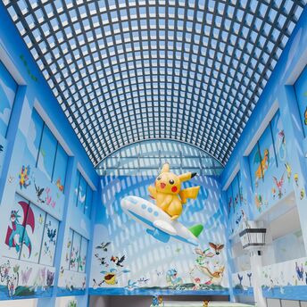Pokémon-themed airport atrium with Pikachu on a plane