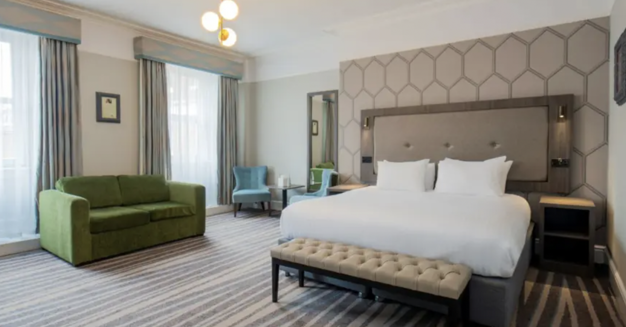Guest room at The Queen at Chester Hotel with bed and seating area