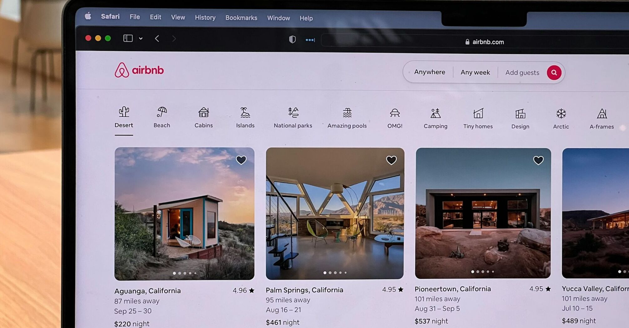 Airbnb listings displayed on a laptop screen