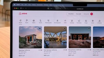 Airbnb listings displayed on a laptop screen