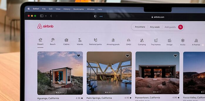 Airbnb listings displayed on a laptop screen
