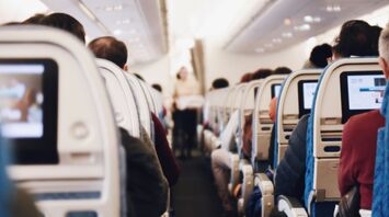 Passengers seated inside aircraft cabin during flight