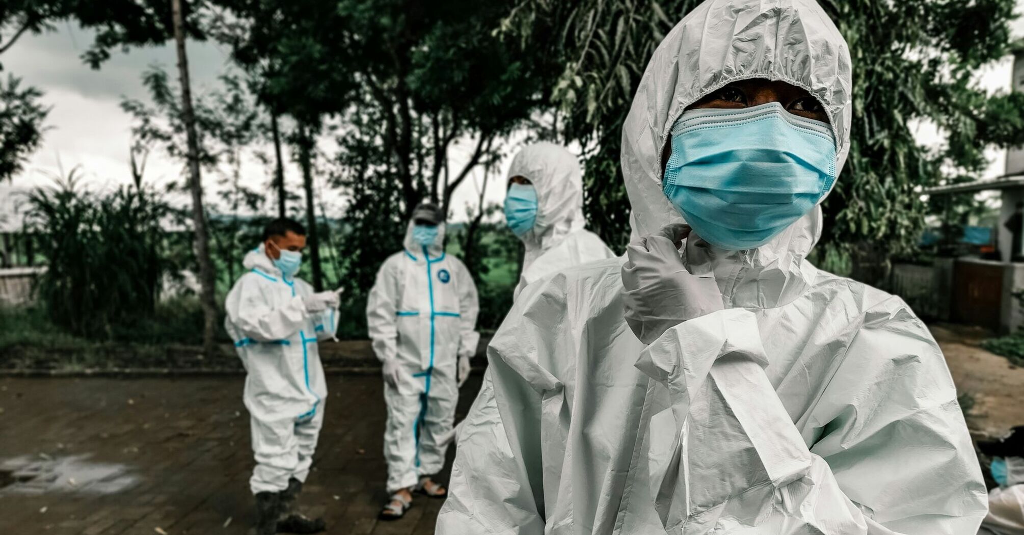 Health workers in protective suits and masks during an outbreak response