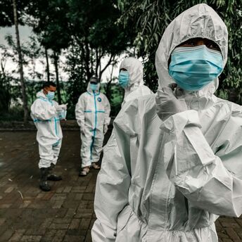 Health workers in protective suits and masks during an outbreak response