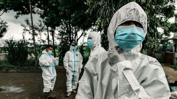 Health workers in protective suits and masks during an outbreak response
