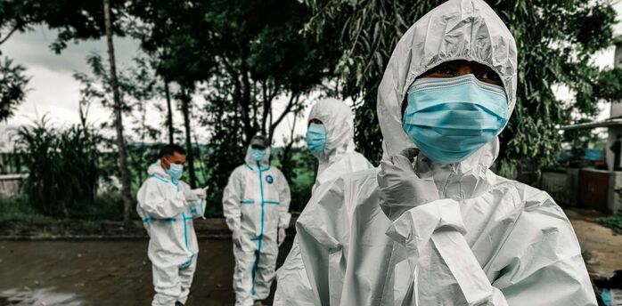 Health workers in protective suits and masks during an outbreak response