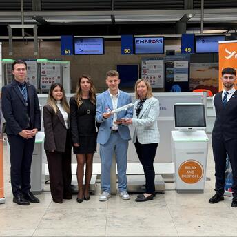 Freebird Airlines and Nuremberg Airport staff beside self bag drop counters