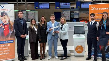 Freebird Airlines and Nuremberg Airport staff beside self bag drop counters