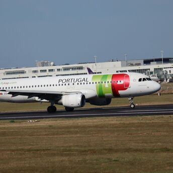 TAP Air Portugal aircraft taxiing at an airport runway