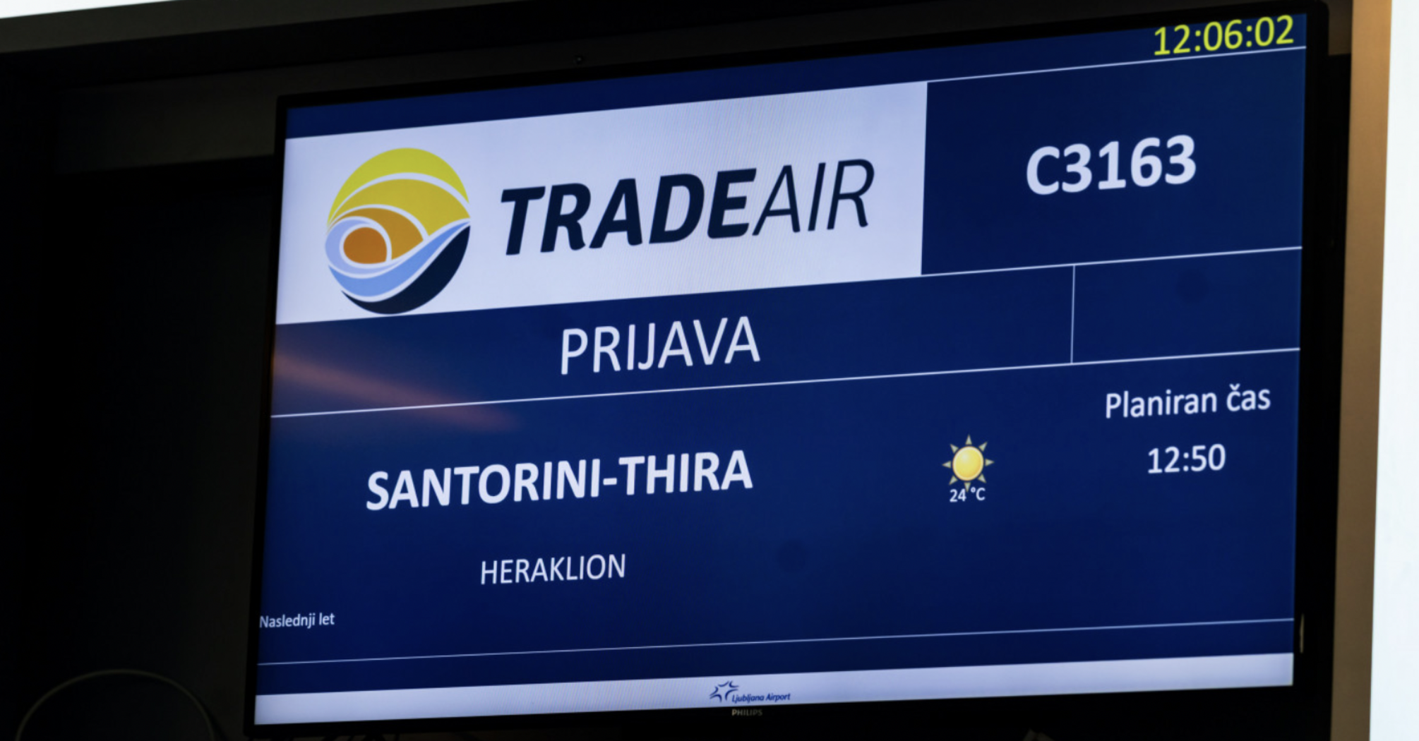Ljubljana Airport screen showing a Trade Air flight to Santorini and Heraklion