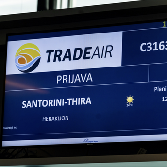 Ljubljana Airport screen showing a Trade Air flight to Santorini and Heraklion