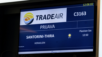 Ljubljana Airport screen showing a Trade Air flight to Santorini and Heraklion
