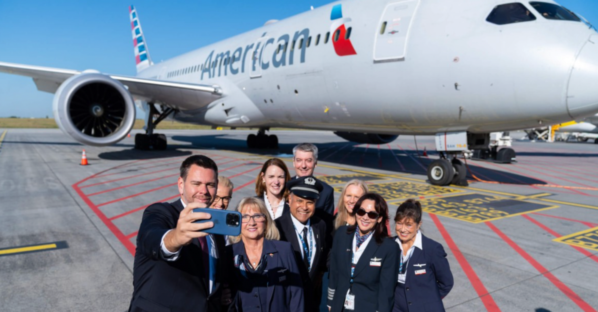 American Airlines crew taking a selfie beside a Boeing aircraft