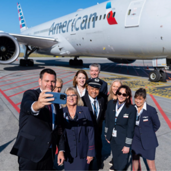 American Airlines crew taking a selfie beside a Boeing aircraft