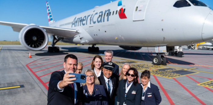 American Airlines crew taking a selfie beside a Boeing aircraft