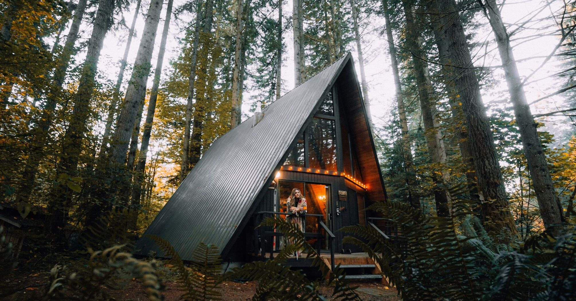 A-frame cabin in a forest listed as a holiday rental