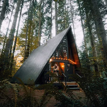 A-frame cabin in a forest listed as a holiday rental