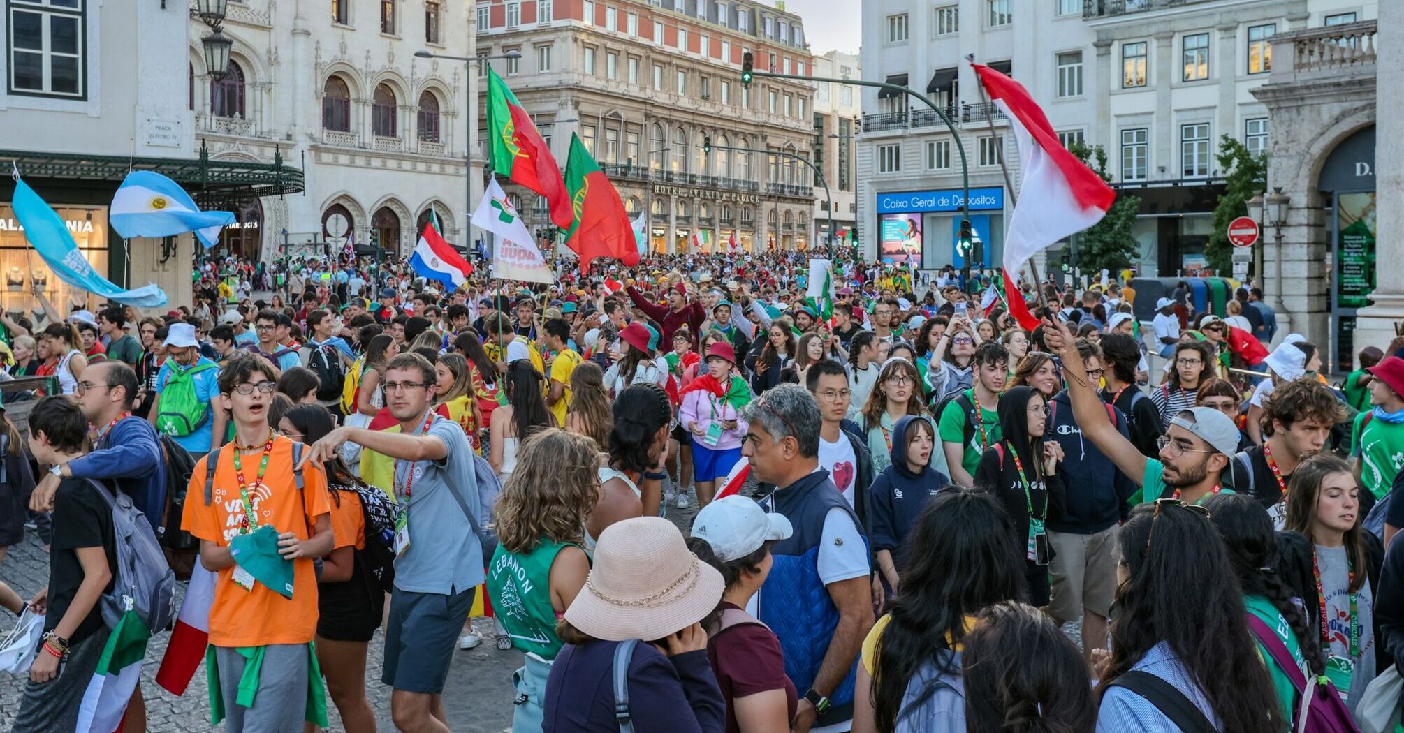 Large crowd gathered in central Lisbon with flags