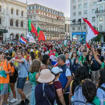 Large crowd gathered in central Lisbon with flags