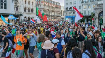 Large crowd gathered in central Lisbon with flags