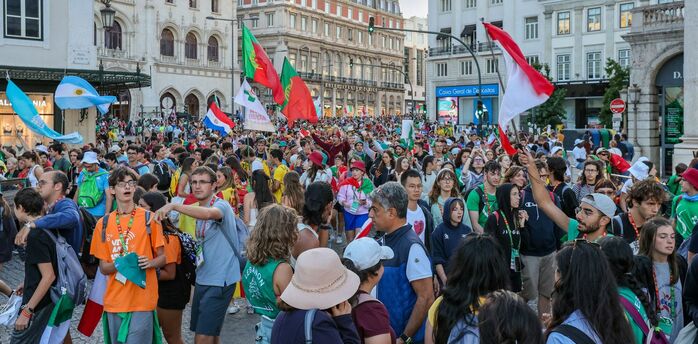 Large crowd gathered in central Lisbon with flags