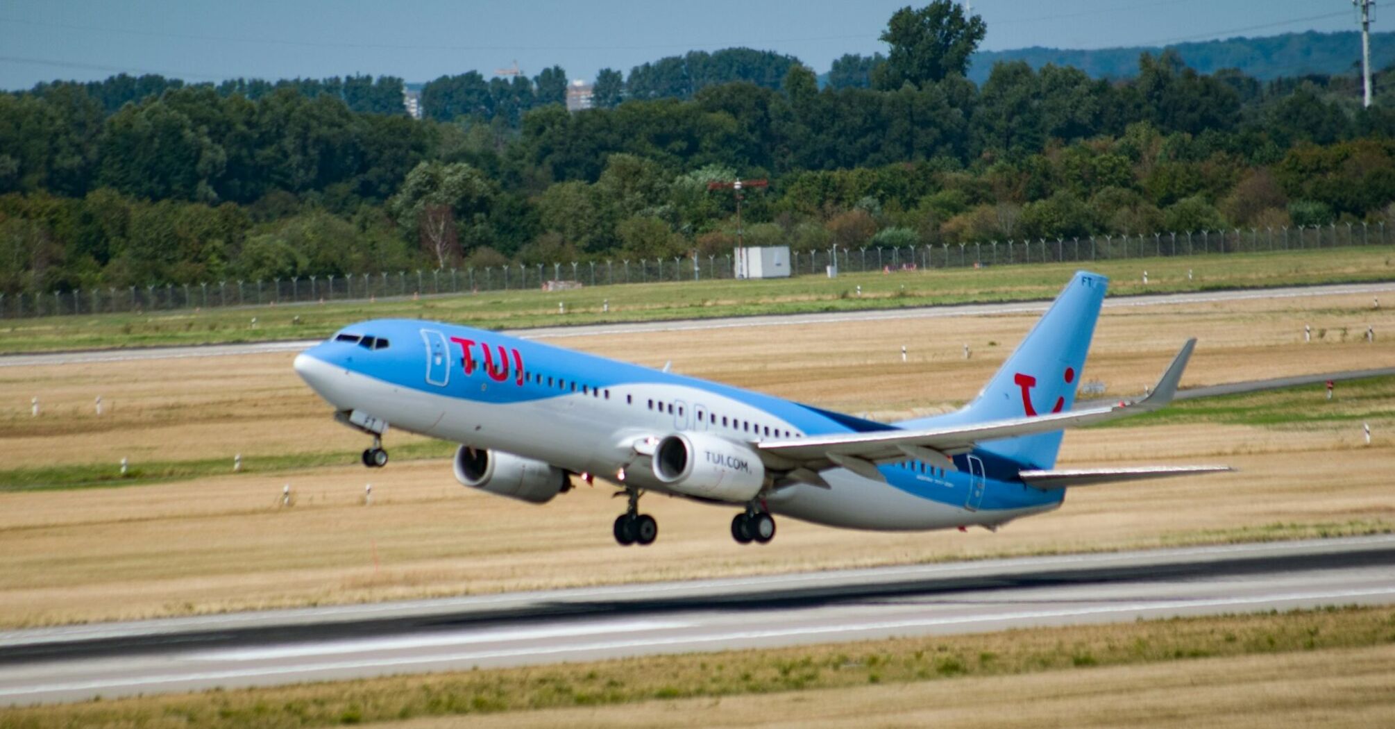 TUI aircraft taking off from an airport runway