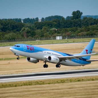 TUI aircraft taking off from an airport runway