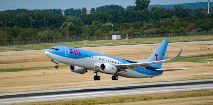 TUI aircraft taking off from an airport runway