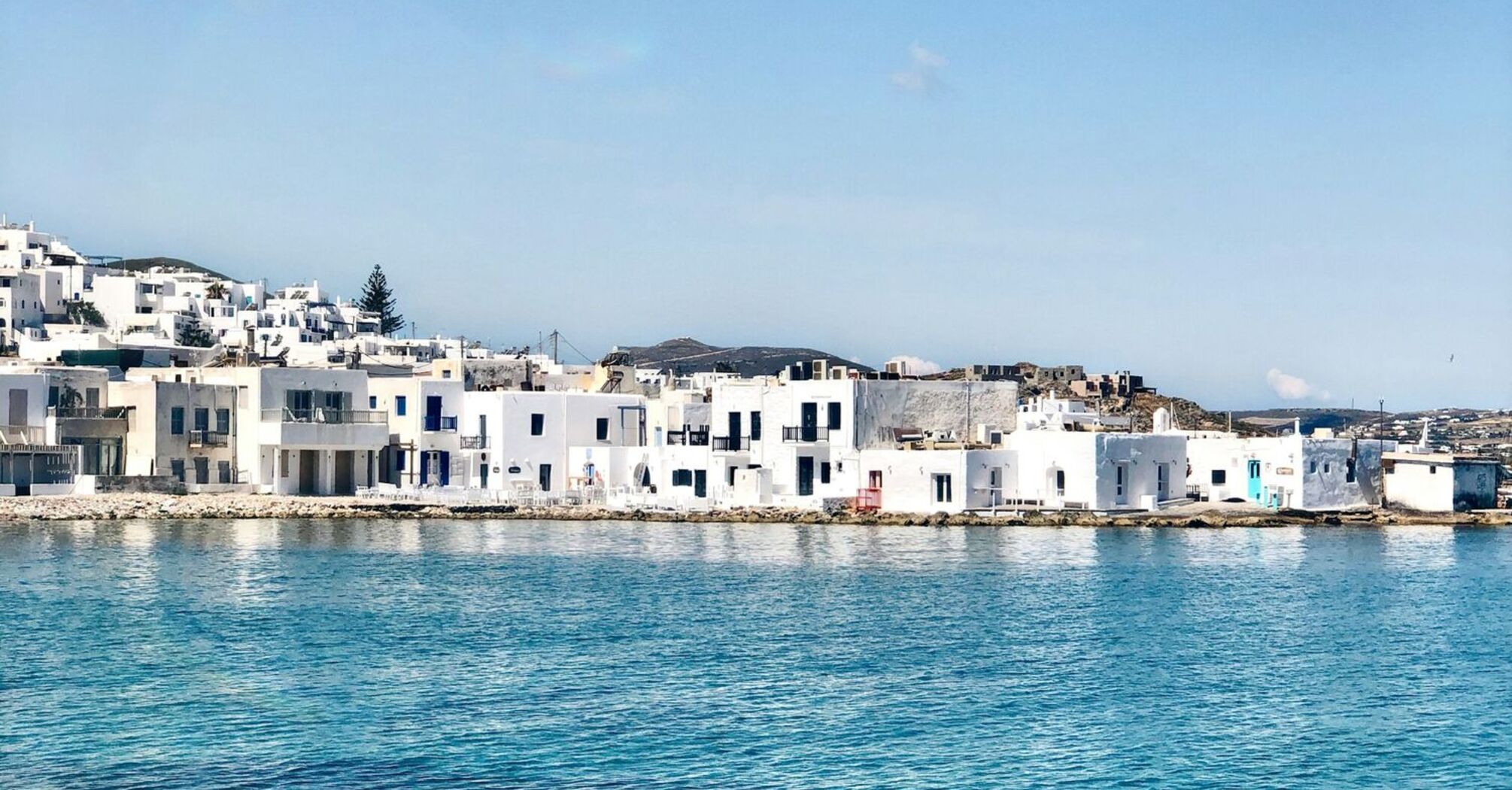 White buildings beside clear blue water on Paros