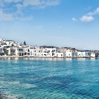 White buildings beside clear blue water on Paros