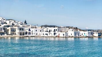 White buildings beside clear blue water on Paros