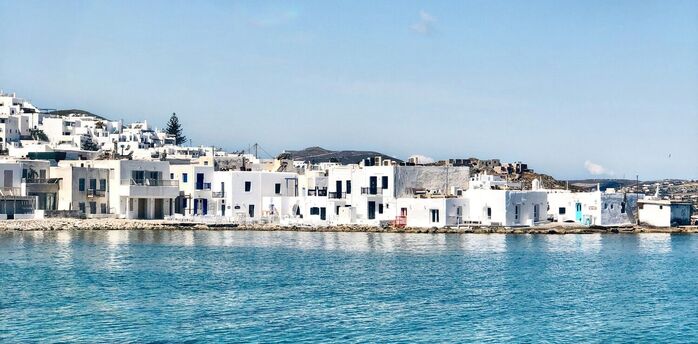 White buildings beside clear blue water on Paros